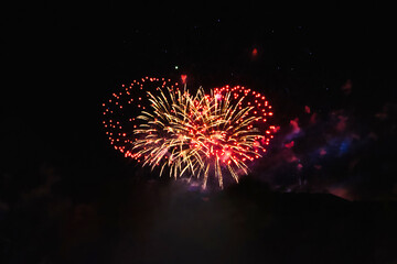 Firework over the ordinary European city.  Amateur photo. Noise. Grain.