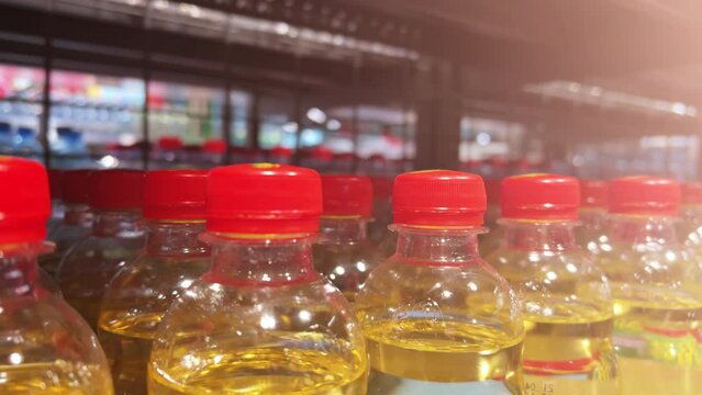 Soda pop in plastic bottles is on the shelves of grocery store. Closeup