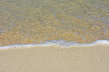 Water Gently Lapping the Shore with Small Bubbles