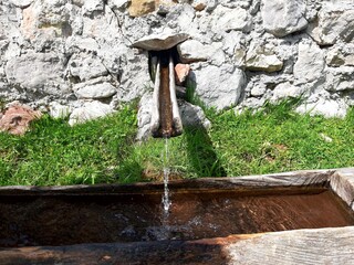 Natural mountain water flowing from rocks near Umoljani, mountain Bjelasnica, Bosnia and Herzegovina