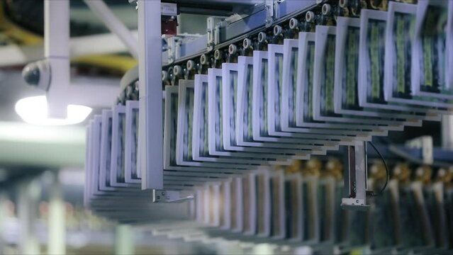 Pre-production of magazines in print house as seen from below. Traditional newspaper printing along conveyor belt with colorful ink. High quality FullHD footage