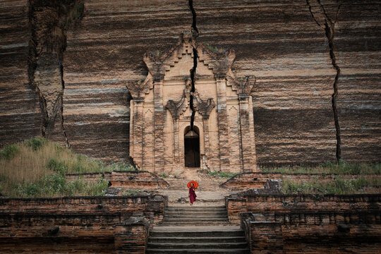 Novice Buddhist monk at the ruins of the Mingun Pahtodawgyi Pagoda in Sagaing, Mandalay, Myanmar (Burma).