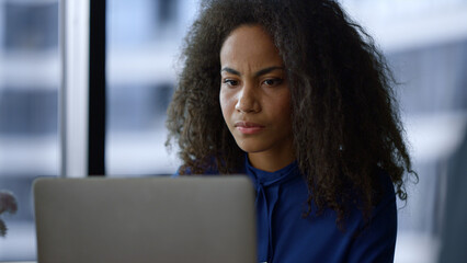 Serious executive african american woman work computer drinking coffee in office