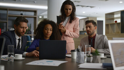 Multiracial corporate group discuss finance plan. Business team searching laptop