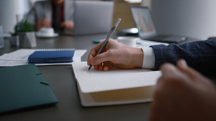 Businessman hands writing paper filling document application on office meeting.