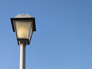 Fototapeta na wymiar single streetlight during the day with blue sky background