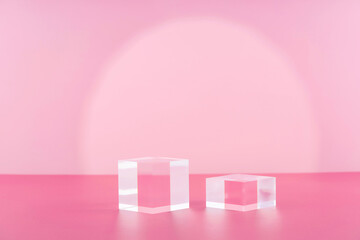 Acrylic blocks on pink background, pedestal cosmetic display glass podium platform for product...