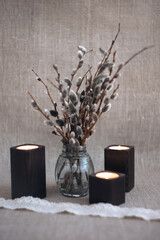 Willow. Still-life. A bouquet of willow. Willow branches. Candles. Candlesticks.