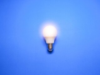Idea concept. Lightbulb isolated with blue background.