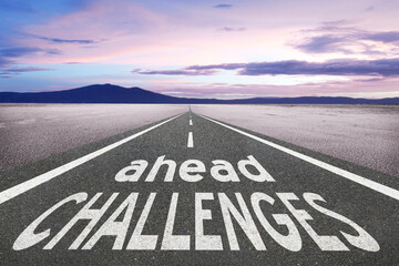 Challenges ahead text on road into the future.