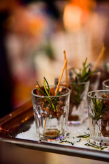 glass with aperitif and rosemary
