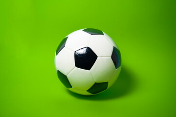 Photo of Soccer ball on fluorescent green backdrop 