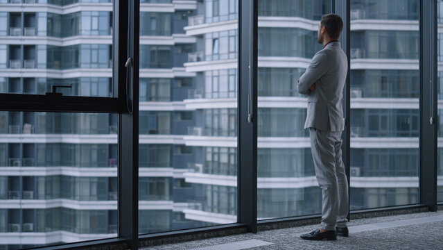 Successful Man Crossing Hands Looking Window In Business Office Building Centre.