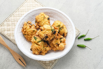 Perkedel Tahu, Made from mashed tofu, tapioca flour, spring onion, egg, salt and pepper. Served in white plate.
