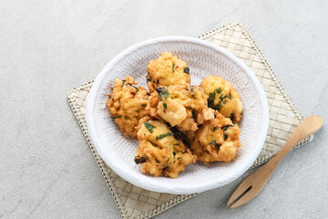 Perkedel Tahu, Made from mashed tofu, tapioca flour, spring onion, egg, salt and pepper. Served in white plate.
