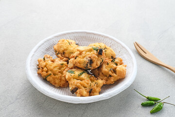 Perkedel Tahu, Made from mashed tofu, tapioca flour, spring onion, egg, salt and pepper. Served in white plate.
