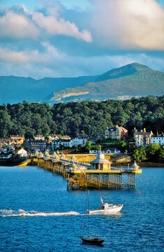 Bangor Pier and town, Gwynedd, north Wales, UK. Looking across the Menai Strait from Anglesey to the mountains of Snowdonia