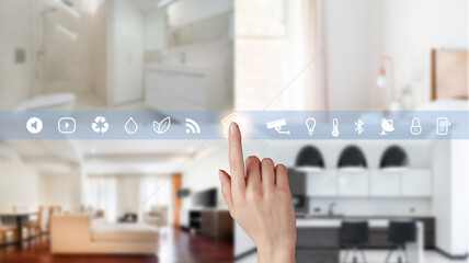 Women hand point smarth home GUI control every room in house. Hand use smart screen smart home automation assistant on a virtual screen and a user touching a button