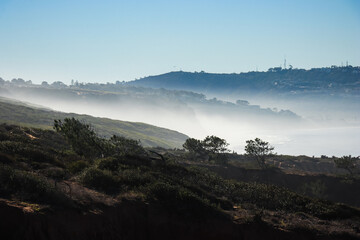 Naklejka na ściany i meble fog over the hills