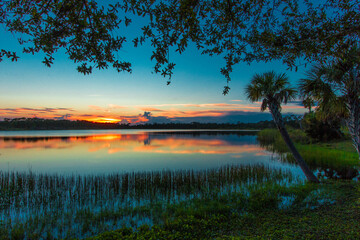Fototapeta na wymiar Colorful Sunset over Lake Zobel, George LeStrange Preserve, Fort Pierce, Florida