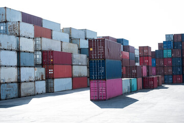 a pile of container in freight yard against a blue sky, transport background