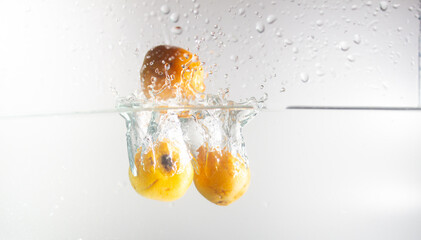 loquat dropping in water splash