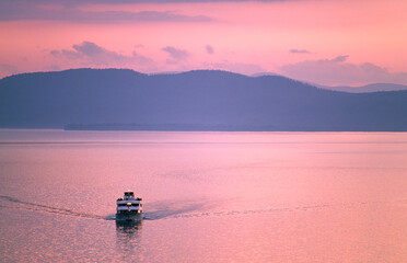Lake Champlain, New England, USA. Cruise boat called Ethan Allen looking west from Vermont shore at Burlington to New York State