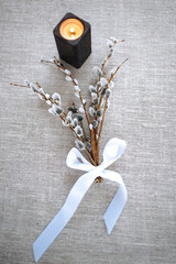 Willow twigs in a vase. A bouquet of willow. Flowers in a vase. Still-life. Candles. Candlesticks.