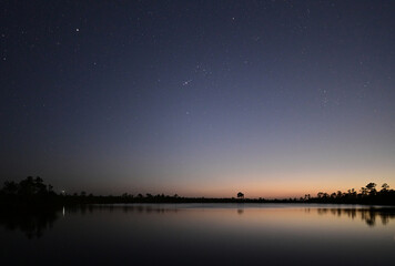 Stars at twilight over Pine Glades Lake in Everglades National Park, Florida on clear April evening.