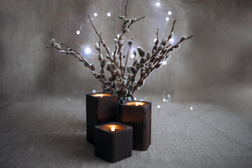 Willow twigs in a vase. A bouquet of willow. Flowers in a vase. Still-life. Candles. Candlesticks.
