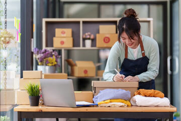 A portrait of Asian woman, e-commerce employee freelance with parcel box for deliver to customer....