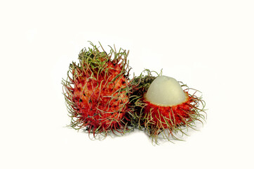 Red rambutan and half peeled rambutan on white