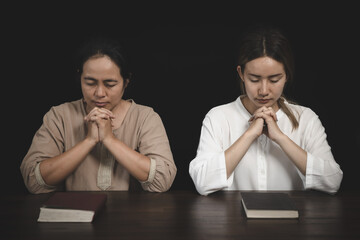 Two women are praying for God's blessing. The idea of praying to the Lord with patience and...