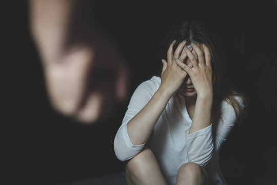 sitting woman holding her head The concept of being physically and mentally abused depression, stress, mental problems Family violence and human trafficking.