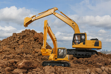 Two crawler excavator  is digging in the construction site work   with sky background
