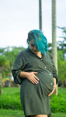 young pregnant woman outdoors in a square at sunset