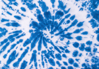 The fabric is dyed blue in a fashionable tie dye style. Flat lay.