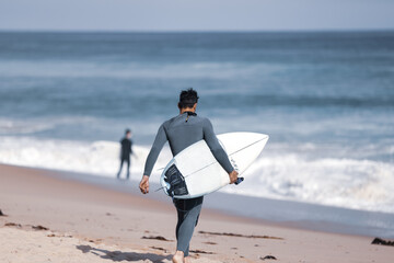 Surfer entering water