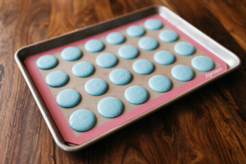 Bakery. Making macaroons. Blue macarons ready for baking lie on a tray on a wooden table. Biscuit