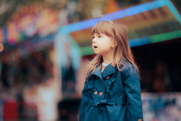 Happy Little Girl Wearing a Trench Coat in Spring Season