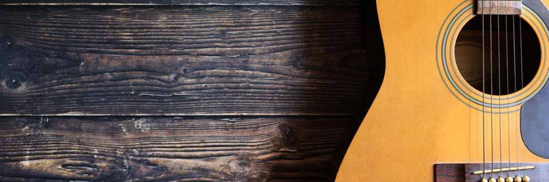 banner of acoustic guitar on the wooden background music template concept.