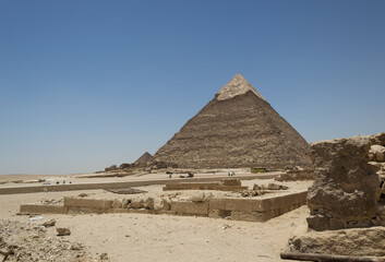 Architectural detail of the Giza pyramid complex located about 13 kilometers southwest of Cairo's city center. In the background, the Pyramid of Khafre or of Chephren