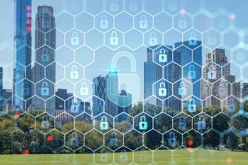 Green lawn at Central Park and Midtown Manhattan skyline skyscrapers at day time, New York City, USA. The concept of cyber security to protect confidential information, padlock hologram