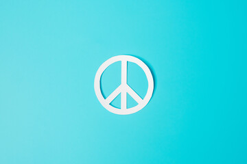 International Day of Peace. white paper Peace symbol on blue background. Freedom, Hope, World Peace day 21 September and Nuclear Disarmament concepts..