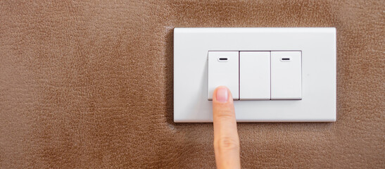 finger turn on or off on light switch on wall at home. Energy Saving, power, electrical and...
