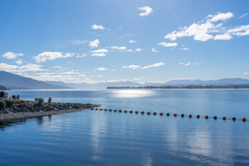 Row of buoys strung across lake by Keplar central gates on Lake Te Anau