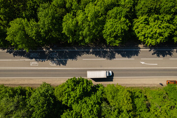 Road through the green forest, aerial view car drive going through forest, top down view forest, view from above, ecosystem and healthy environment concept and background.