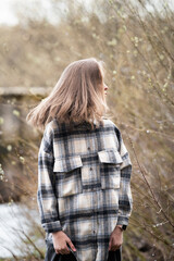 teenage girl in a plaid shirt in nature