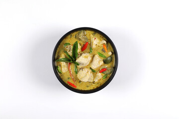 Thai food, Green curry chicken in a black bowl Isolated on white background, top view have copy space.