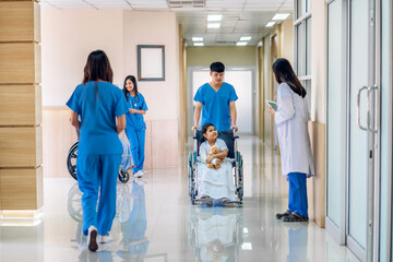 Asian smiling woman doctor service help support discussing and consulting talk to little girl patient give teddy bear and check up information in hospital © Art_Photo